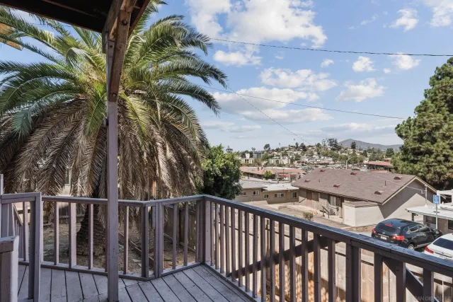a view of a balcony with wooden fence