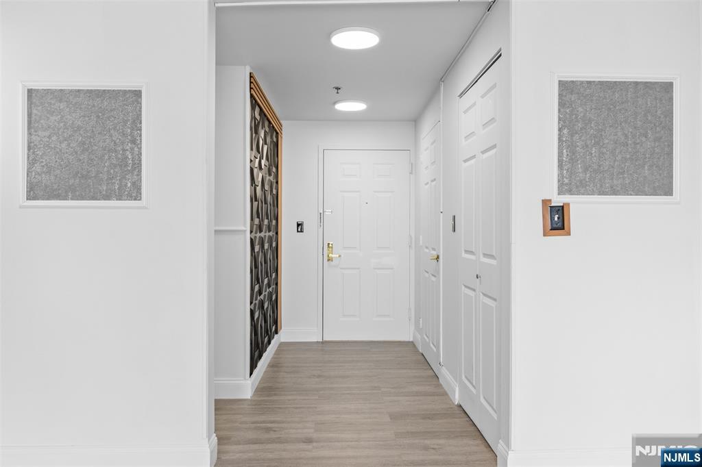 100 Old Palisade Road, Unit 3215 Fort Lee, NJ 07024 - Photo 12 of 43 a view of a hallway with wooden floor