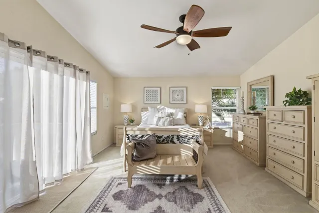 a living room with furniture a ceiling fan and a window