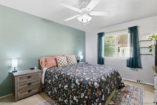 a bed sitting in a bedroom next to a window