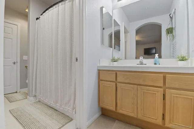 a bathroom with a double vanity sink and a mirror