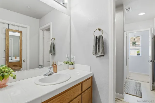a bathroom with a sink vanity and mirror