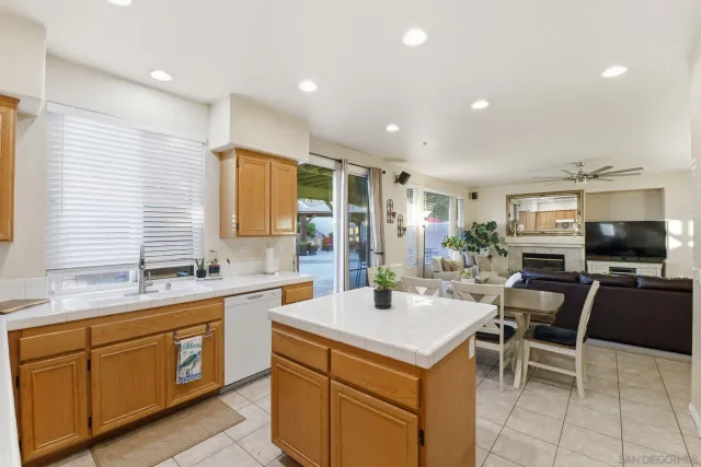 a kitchen with a sink a counter top space appliances and cabinets