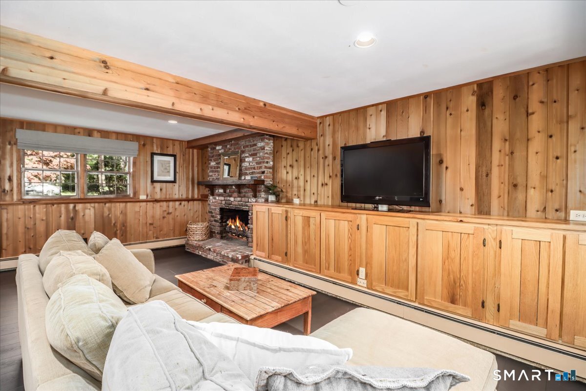 28 Fieldcrest Drive Ridgefield, CT 06877 - Photo 20 of 36 a living room with furniture and a flat screen tv