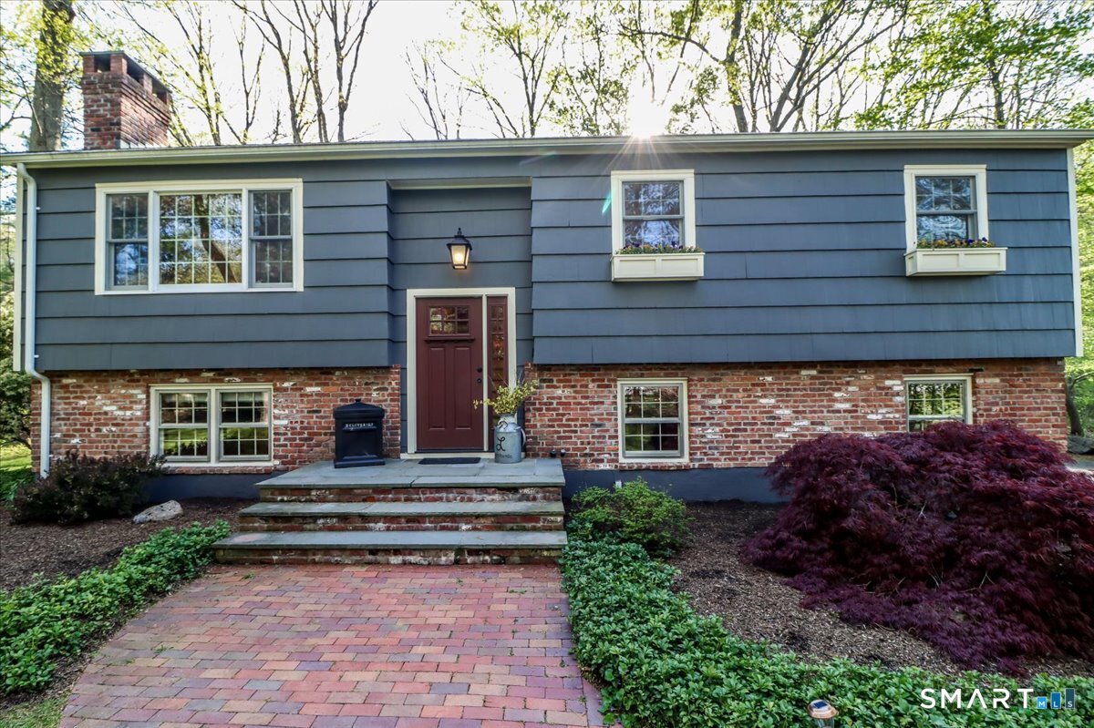 28 Fieldcrest Drive Ridgefield, CT 06877 - Photo 2 of 36 a view of a house with a small yard plants and large tree