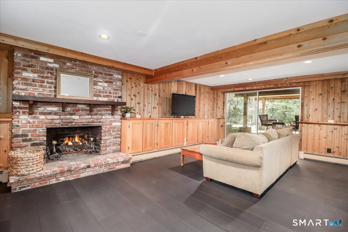 28 Fieldcrest Drive Ridgefield, CT 06877 - Photo 21 of 36 a living room with furniture and a fireplace
