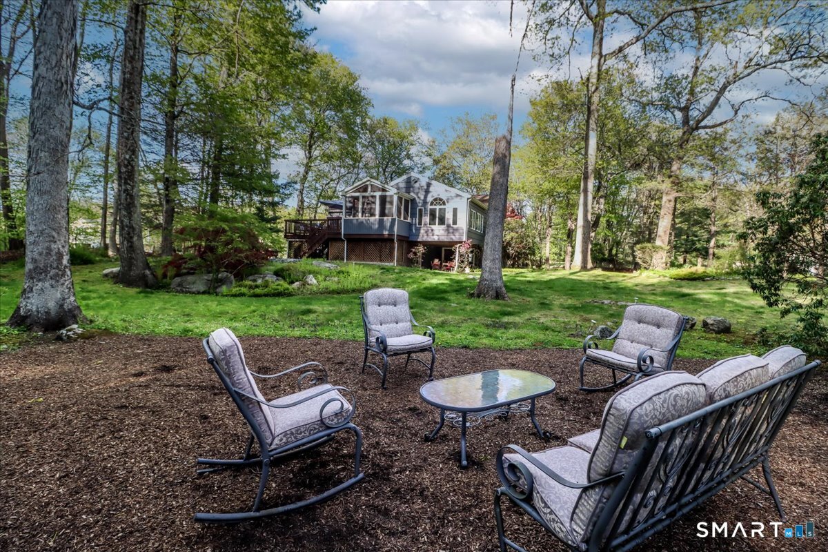 28 Fieldcrest Drive Ridgefield, CT 06877 - Photo 32 of 36 a view of a patio with a table chairs and a yard
