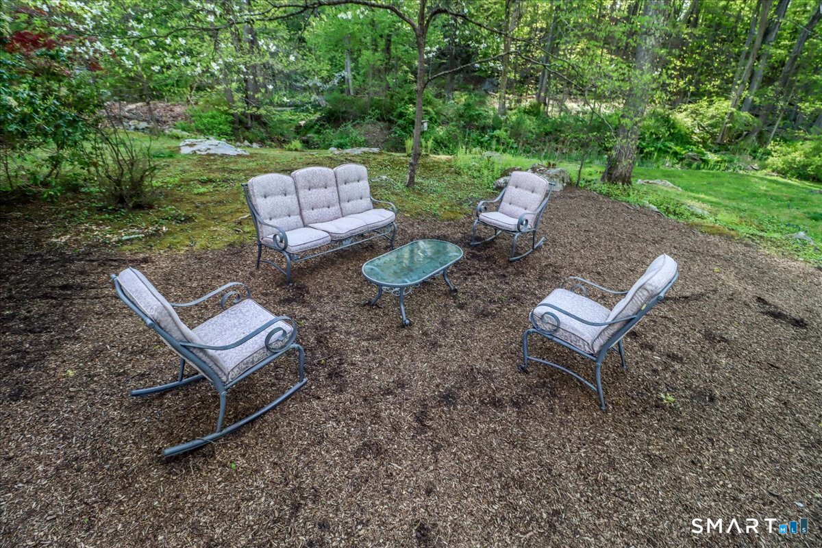 28 Fieldcrest Drive Ridgefield, CT 06877 - Photo 33 of 36 a view of a backyard with couple of chairs