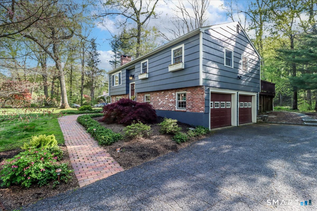 28 Fieldcrest Drive Ridgefield, CT 06877 - Photo 34 of 36 a front view of a house with garden