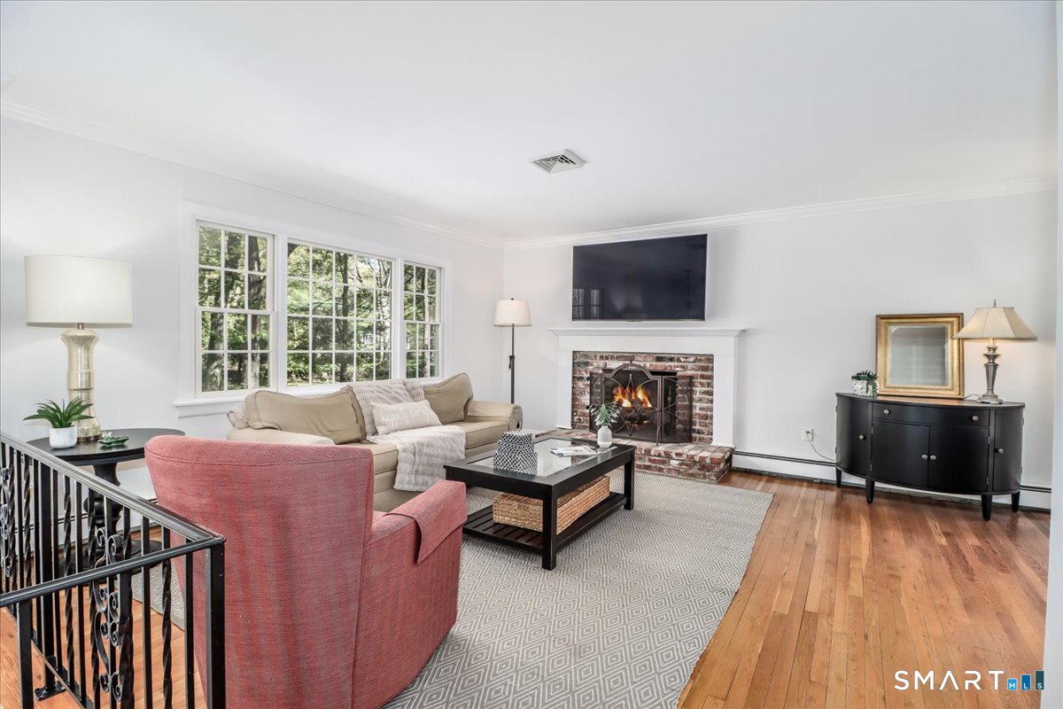 28 Fieldcrest Drive Ridgefield, CT 06877 - Photo 5 of 36 a living room with furniture fireplace and flat screen tv