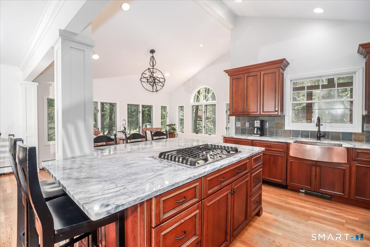 28 Fieldcrest Drive Ridgefield, CT 06877 - Photo 9 of 36 a kitchen with stainless steel appliances granite countertop a stove a sink dishwasher and cabinets with wooden floor