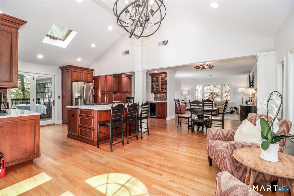 28 Fieldcrest Drive Ridgefield, CT 06877 - Photo 10 of 36 a view of a dining room with furniture a chandelier and wooden floor