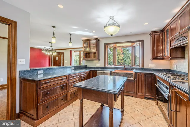 a view of hallway with window and wooden floor