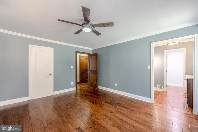 a view of room with wooden floor and ceiling fan
