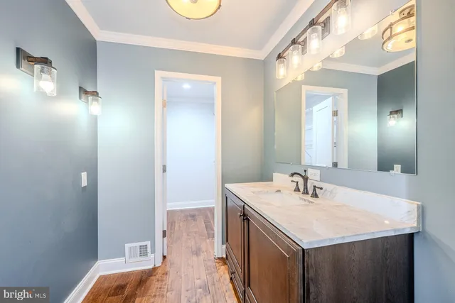 a view of a room with wooden floor and white walls