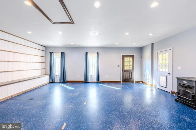 a front view of a house with a garden and trees