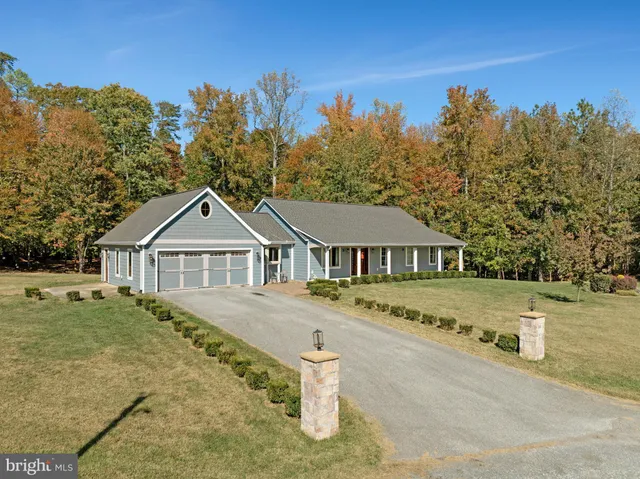 an aerial view of residential house with outdoor space and trees