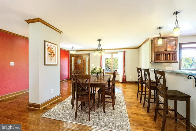 a view of a dining room with furniture and wooden floor