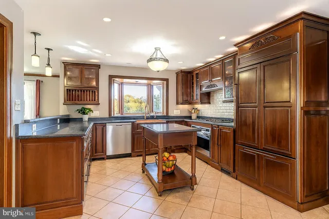 a kitchen with kitchen island granite countertop counter top space appliances and a center island