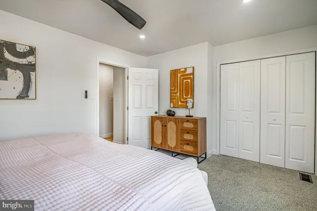 a bedroom with a bed and a dresser