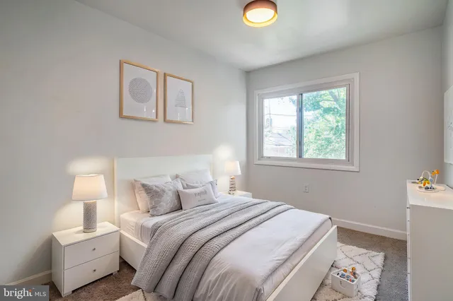 a bedroom with a bed and a lamp