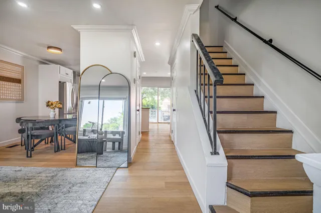 a view of entryway and hall with wooden floor