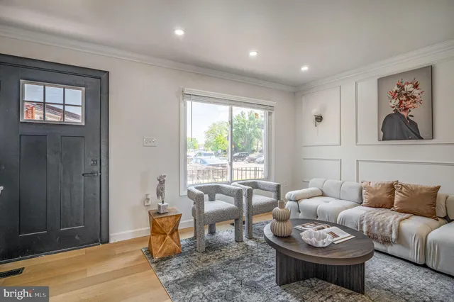 a living room with furniture a rug and a window