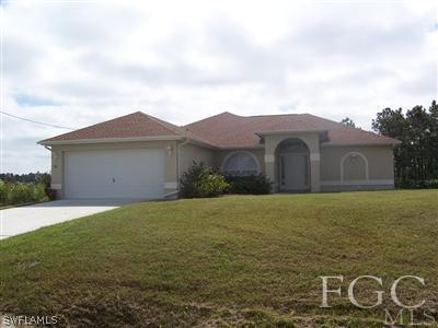 514 Raintree Street East Lehigh Acres, FL 33974 - Photo 1 of 10 a view of an house with backyard and garden