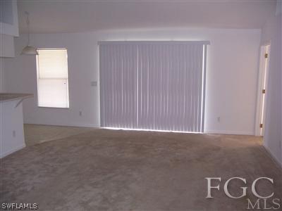 514 Raintree Street East Lehigh Acres, FL 33974 - Photo 2 of 10 a view of an empty room with a window