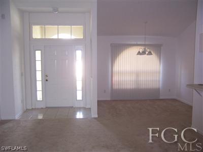 514 Raintree Street East Lehigh Acres, FL 33974 - Photo 4 of 10 an empty room with windows