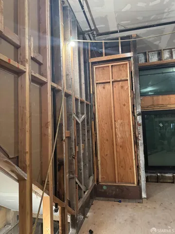 a view of a room with wooden shelves