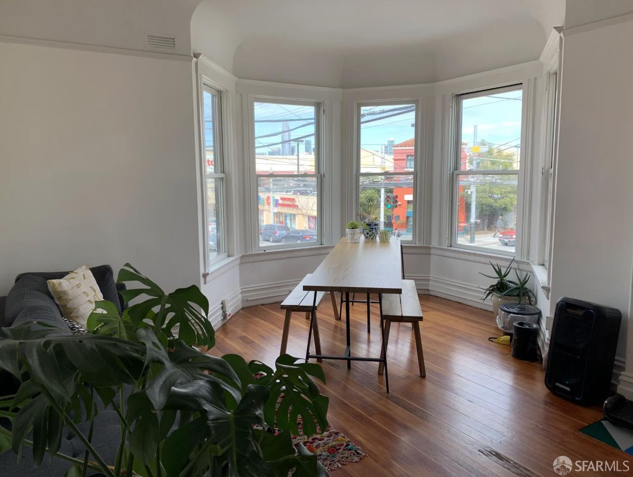 2403 16th Street San Francisco, CA 94110 - Photo 10 of 30 a living room with furniture and a potted plant