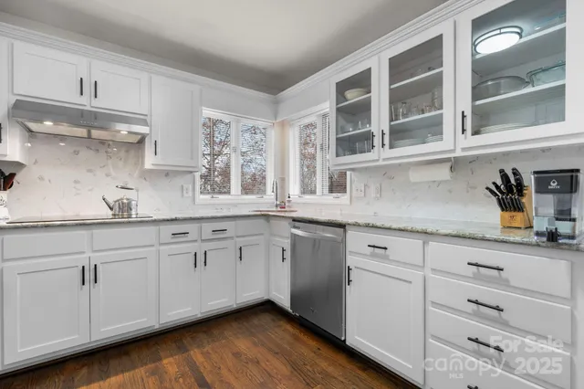 a kitchen with stainless steel appliances a refrigerator sink and cabinets