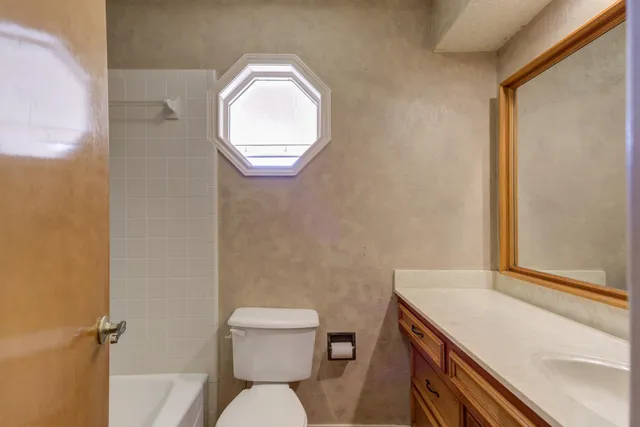 a bathroom with a sink toilet and a mirror