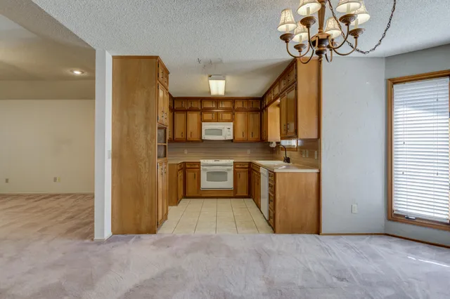 a view of a kitchen with a sink and stainless steel appliances