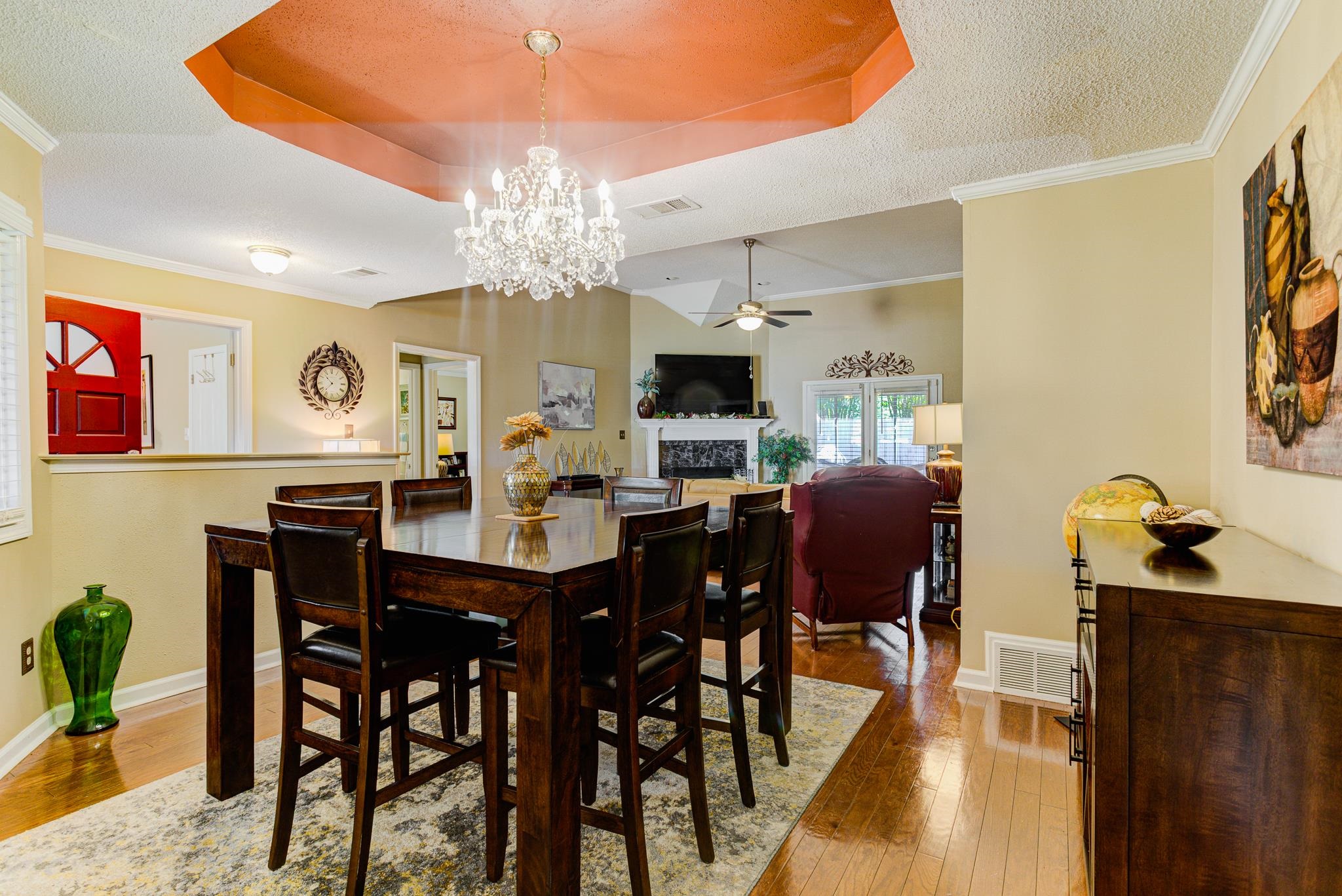 3120 Caledonian Road Memphis, TN 38119 - Photo 8 of 27 Dining room featuring a raised ceiling, hardwood / wood-style flooring, ceiling fan, baseboards, and a textured ceiling