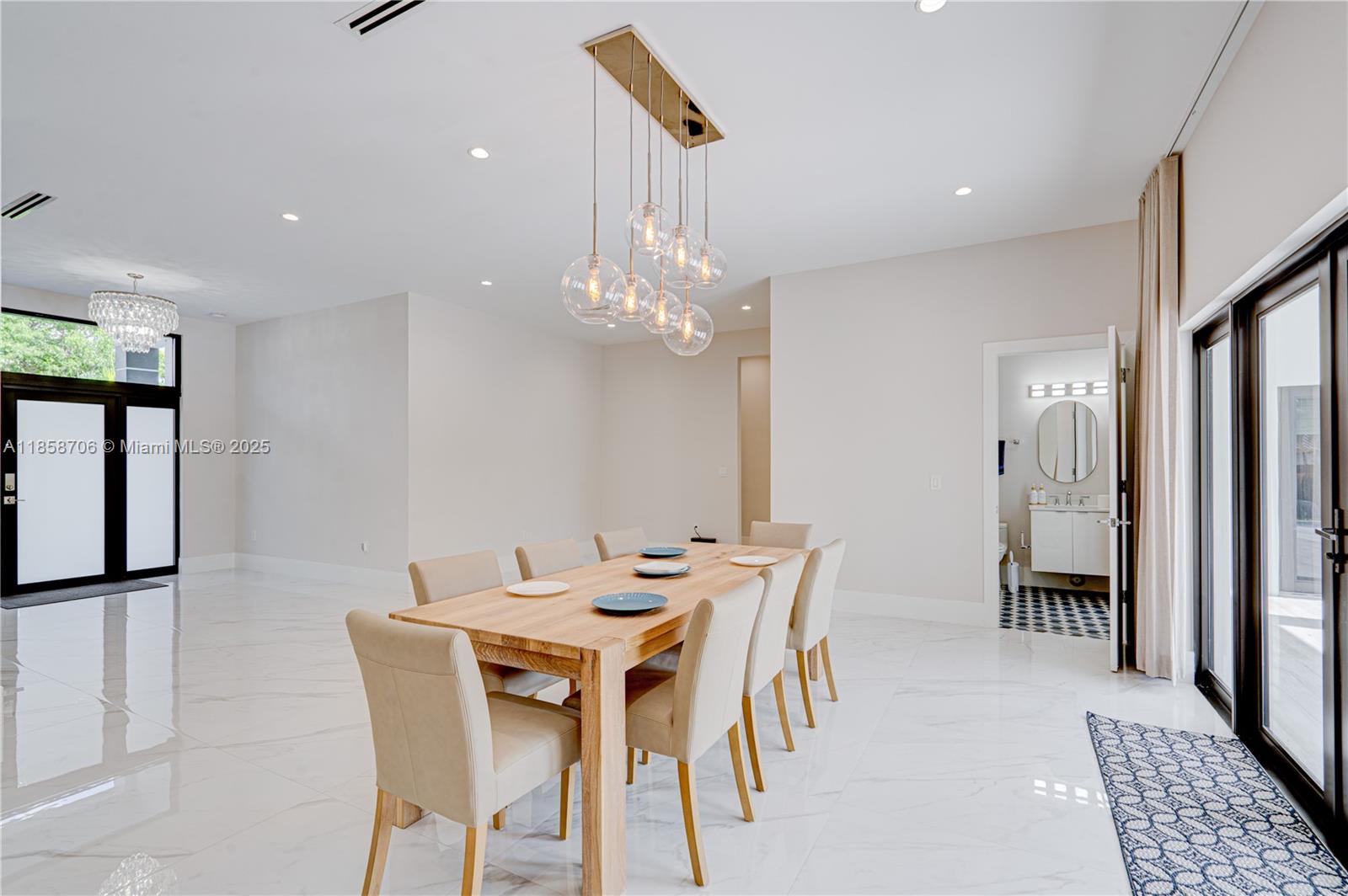 2521 Southwest 105th Avenue Miami, FL 33165 - Photo 17 of 68 a view of a dining room with furniture and a chandelier