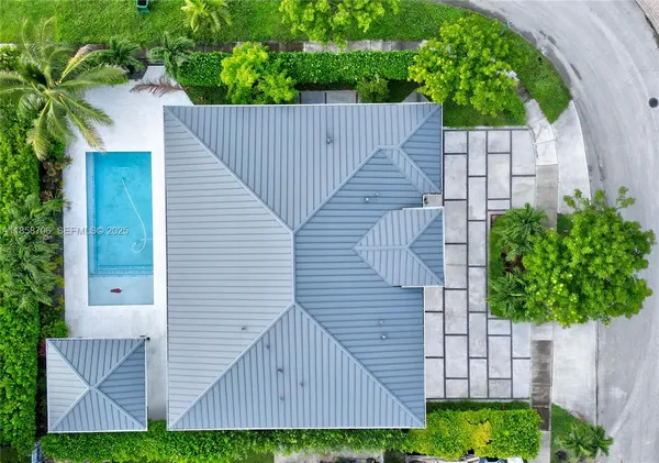 a view of a house with a small yard and wooden fence