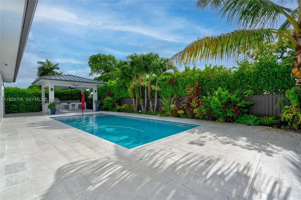 a view of a house with a tree and plants