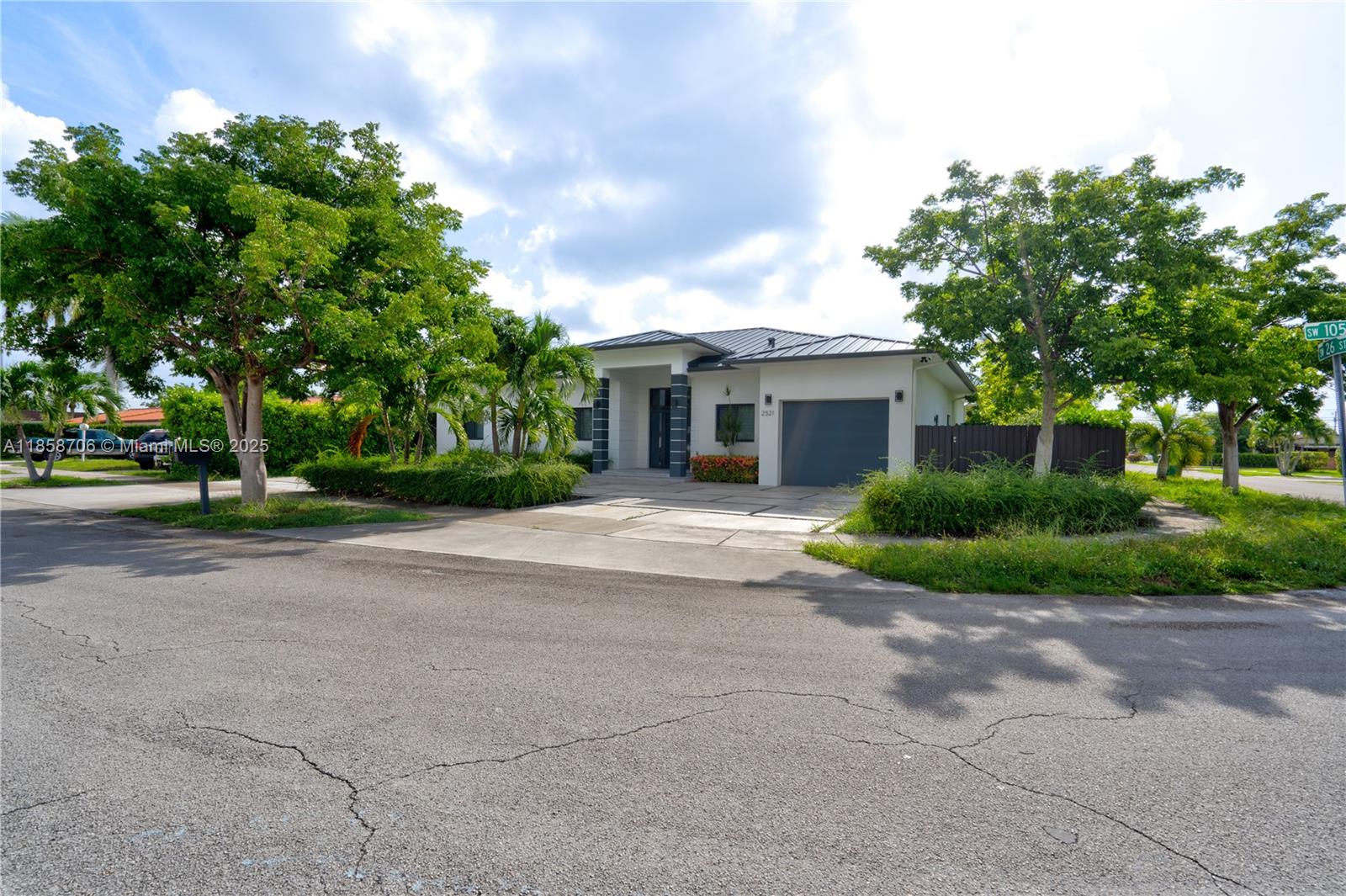 2521 Southwest 105th Avenue Miami, FL 33165 - Photo 30 of 68 a view of a house with a tree and plants