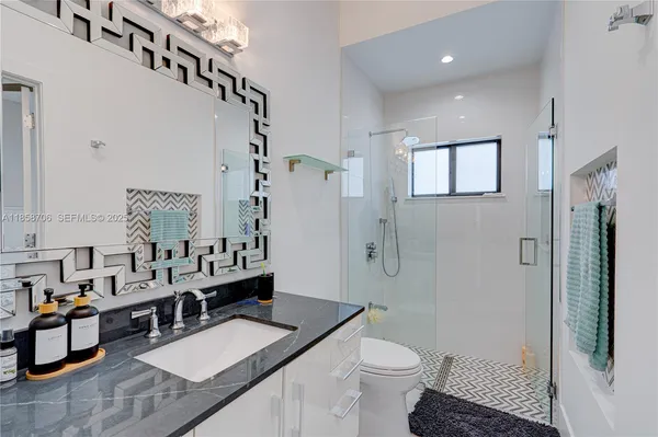 a bathroom with double vanity sinks and a mirror