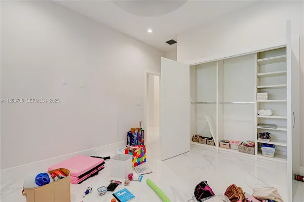 a bedroom with a bed and dresser