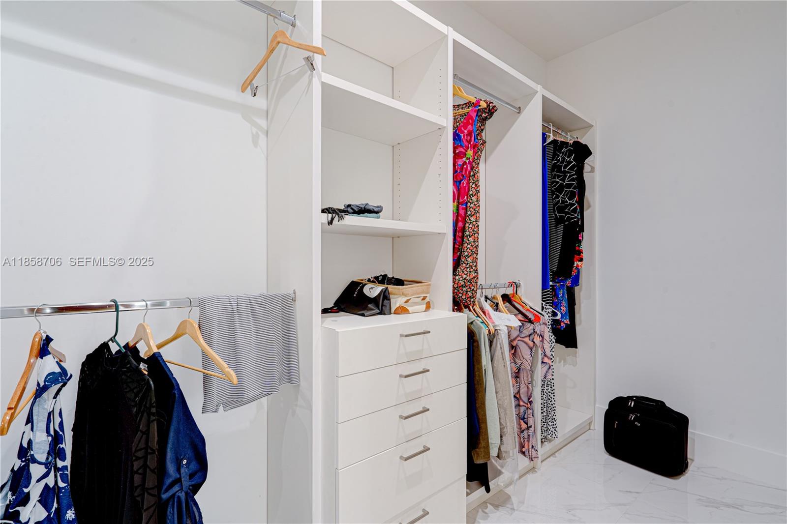 2521 Southwest 105th Avenue Miami, FL 33165 - Photo 53 of 68 a view of walk in closet with clothes and shoes