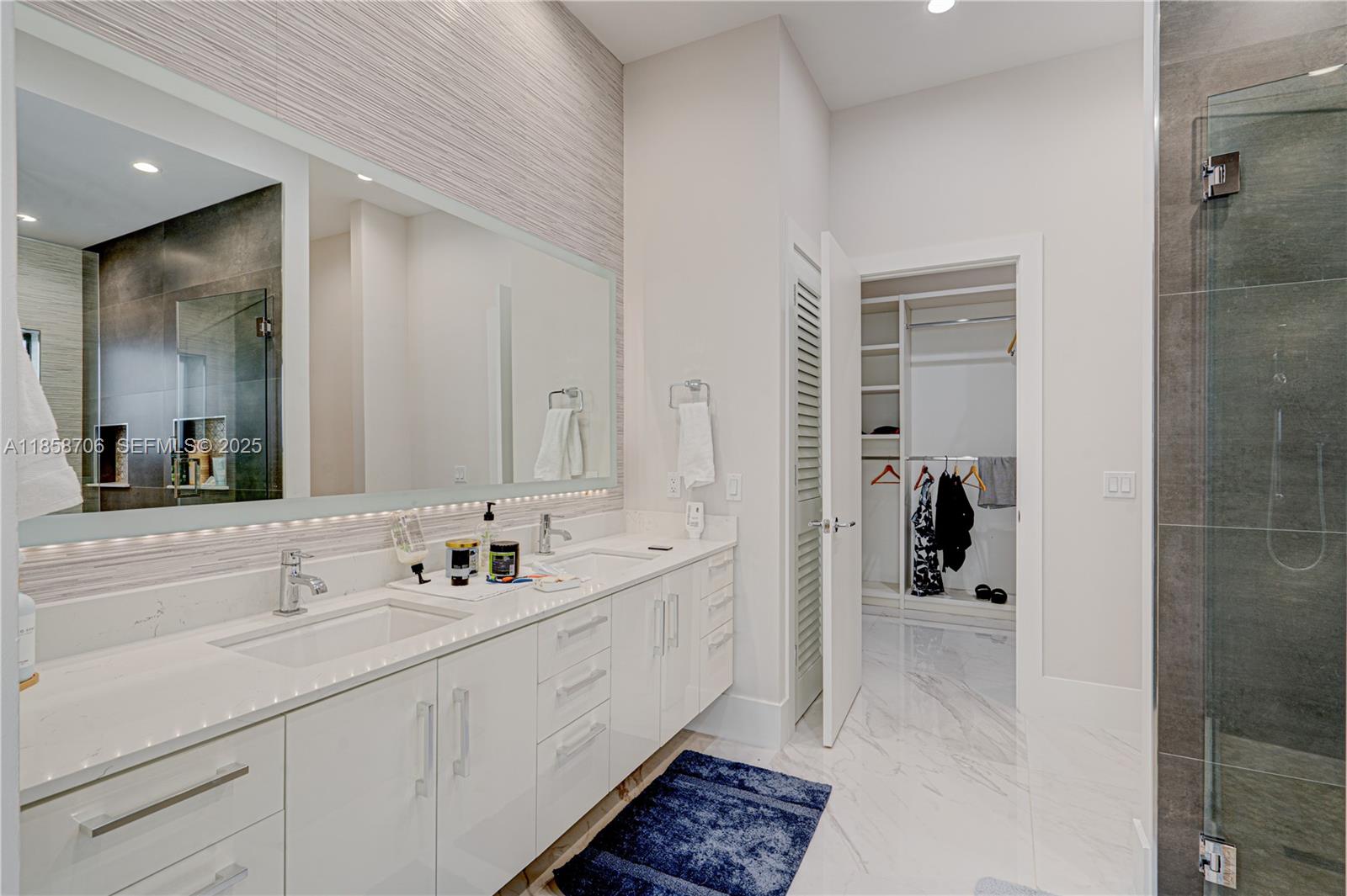 2521 Southwest 105th Avenue Miami, FL 33165 - Photo 60 of 68 a spacious bathroom with a double vanity sink mirror and shower