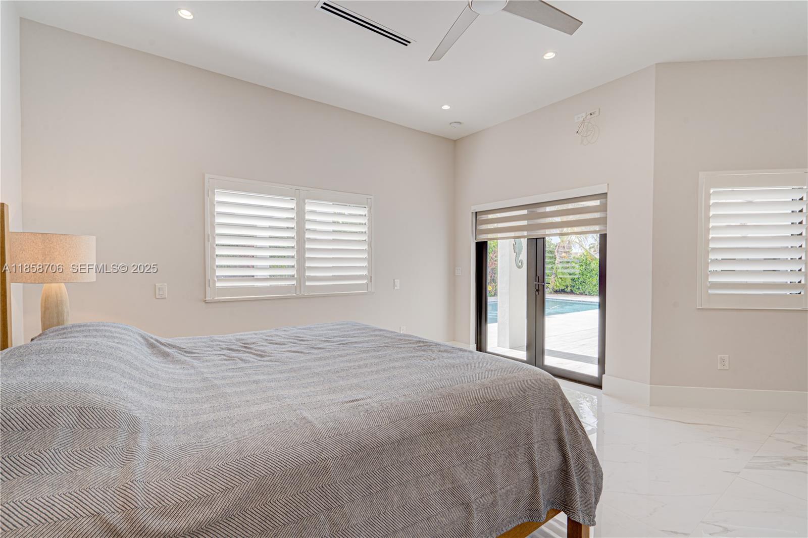 2521 Southwest 105th Avenue Miami, FL 33165 - Photo 61 of 68 a bedroom with a large bed and a large window
