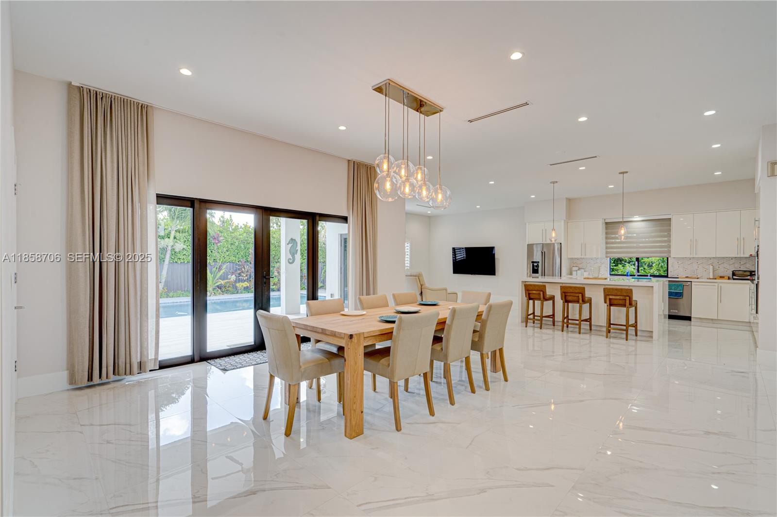 2521 Southwest 105th Avenue Miami, FL 33165 - Photo 7 of 68 a large dining space with furniture a large window and a projector
