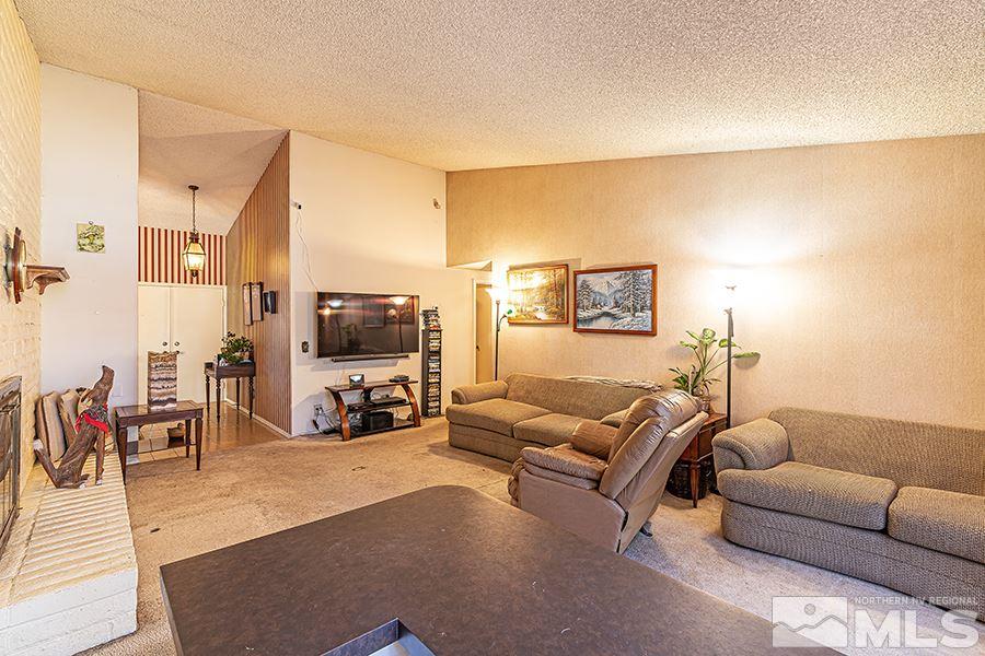 4890 Warren Way Reno, NV 89509 - Photo 8 of 19 a living room with furniture and a flat screen tv