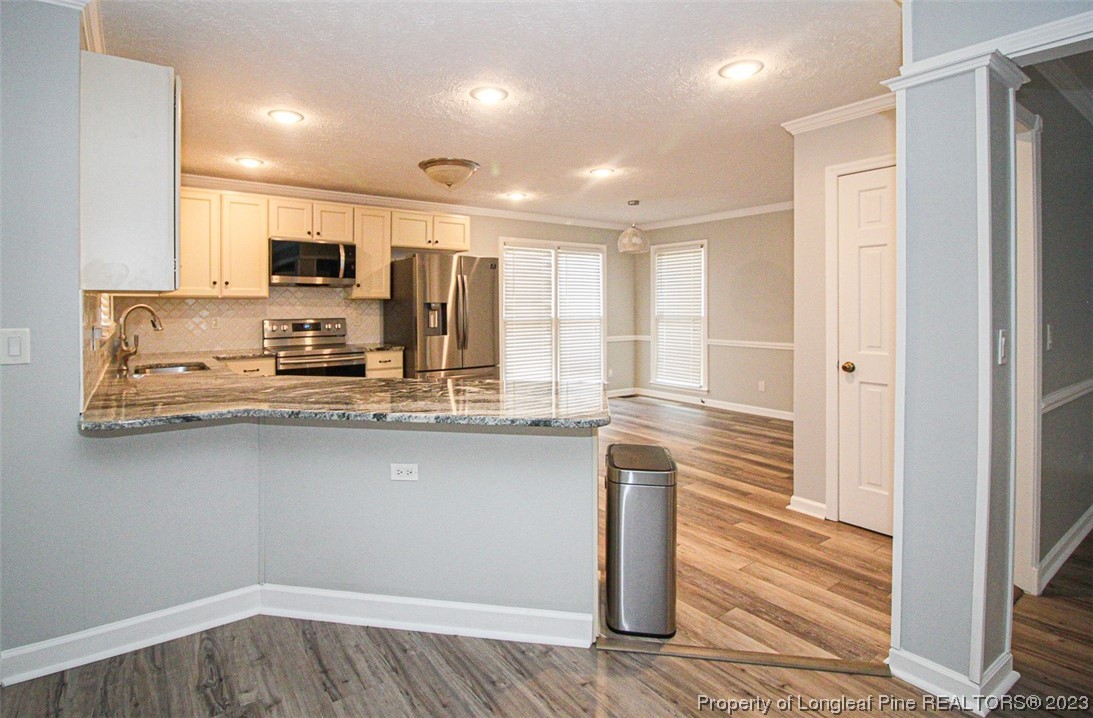 544 Blackbird Road Fayetteville, NC 28314 - Photo 11 of 36 a kitchen with stainless steel appliances granite countertop a sink and a refrigerator