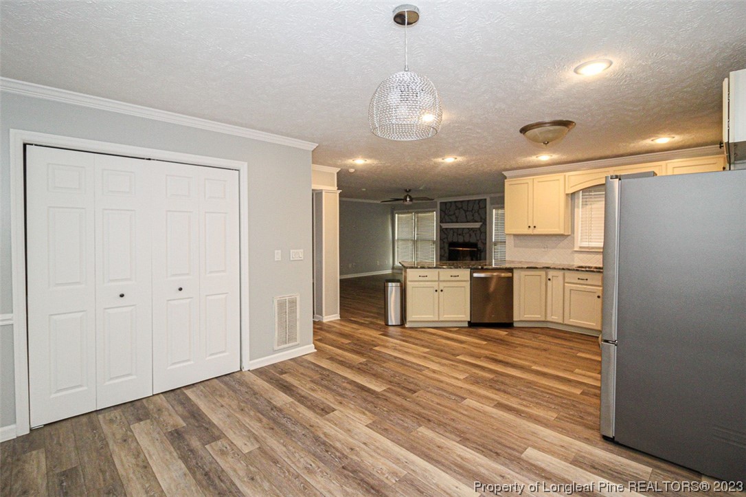 544 Blackbird Road Fayetteville, NC 28314 - Photo 12 of 36 a view of a kitchen with a sink and dishwasher a refrigerator with wooden floor