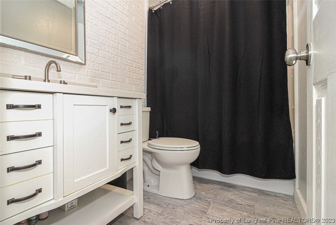 544 Blackbird Road Fayetteville, NC 28314 - Photo 16 of 36 a bathroom with a sink a toilet and shower
